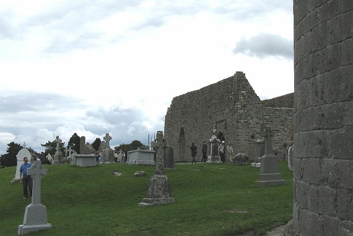 ClonmacnoiseUphillView.jpg - Clonmacnoise - Tombstones and rear of Temple Melaghlin (CN)